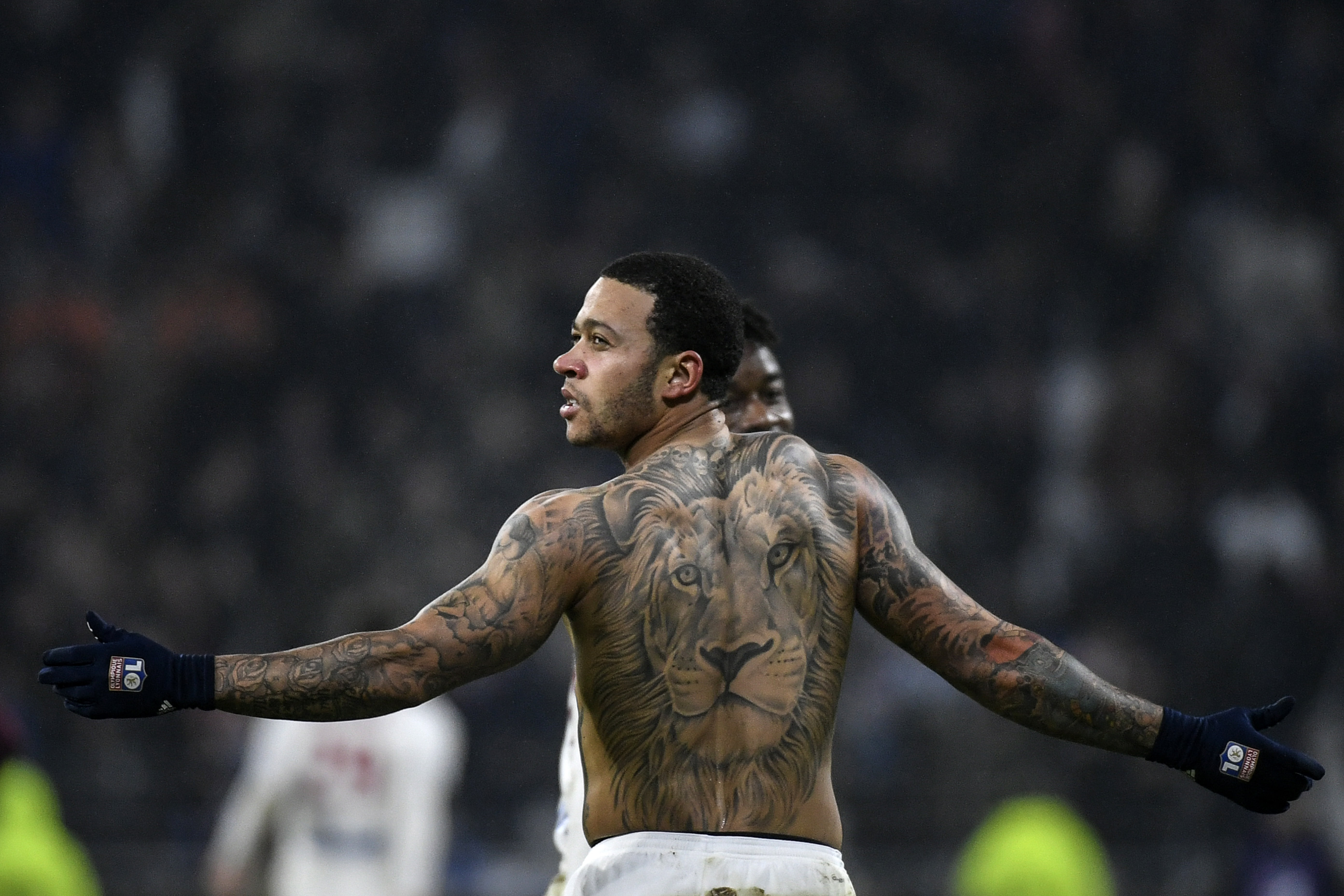 Tattoos are seen on the legs of Memphis Depay of Olympique