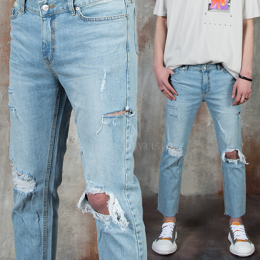 Distressed and ripped light blue jeans